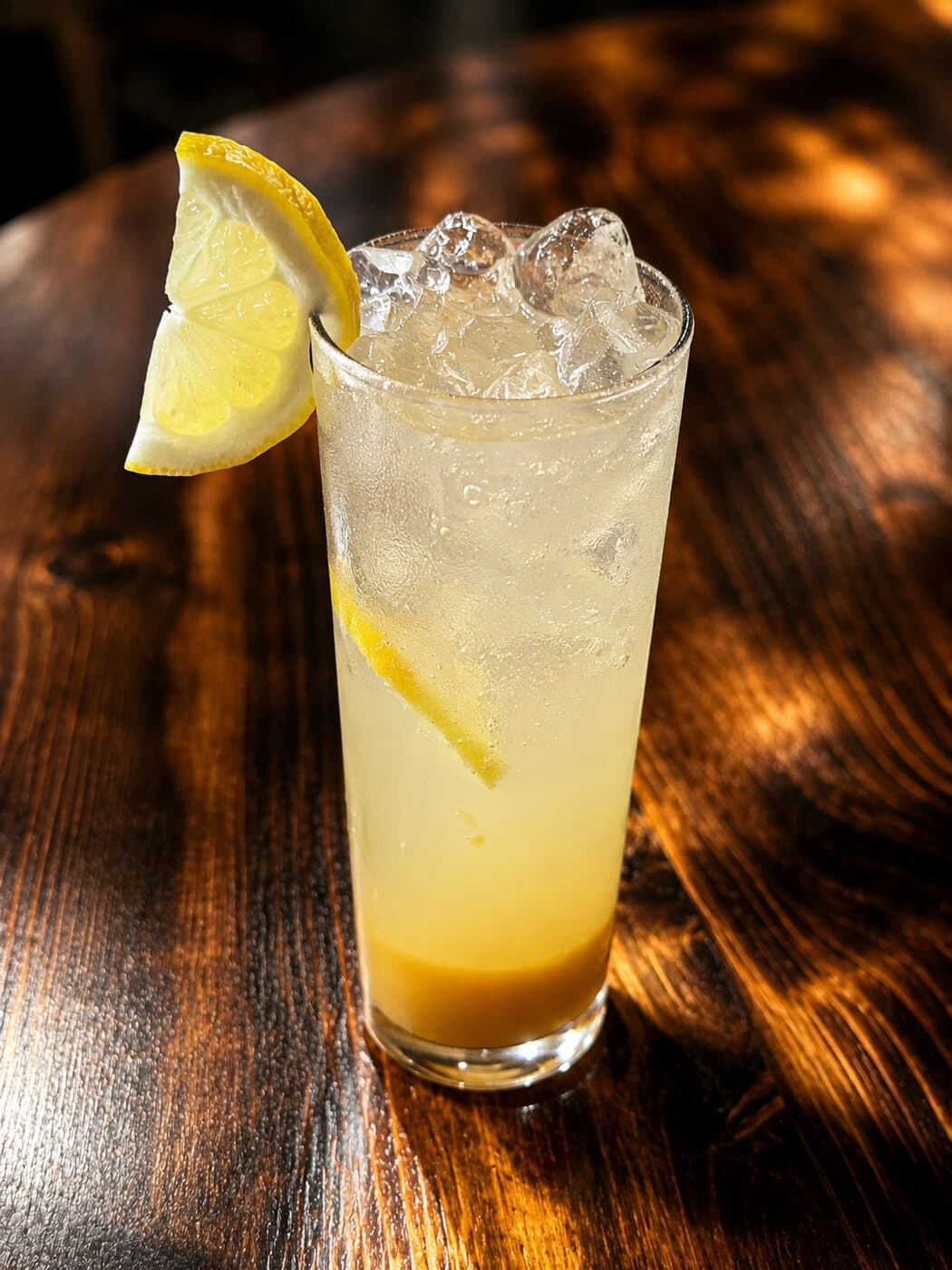 Fresh lemonade with lemon wedge and ice at Mediterra Houston