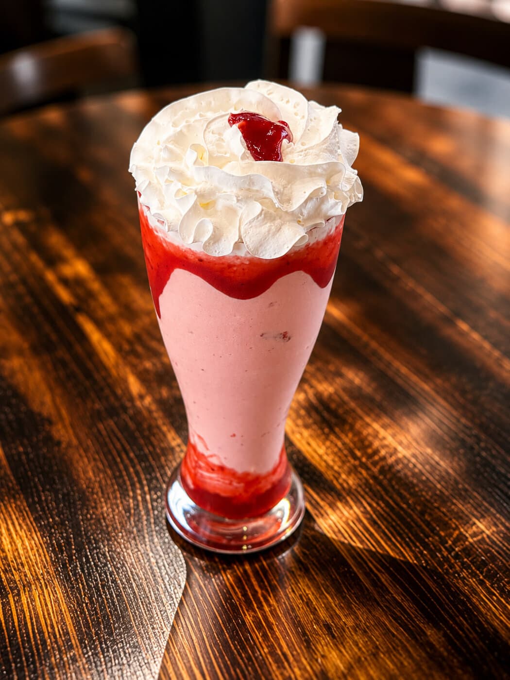 Strawberry milkshake with whipped cream and berry sauce at Mediterra Houston