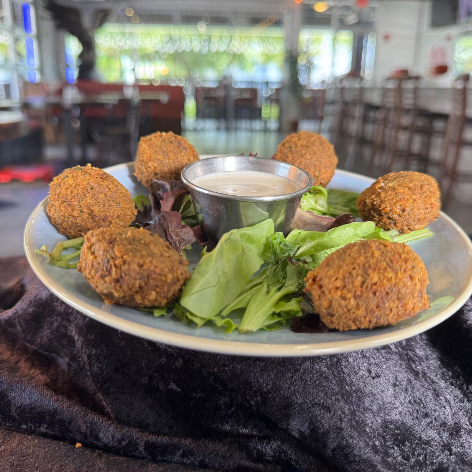 Falafel Plate with tahini and greens at Mediterra Houston