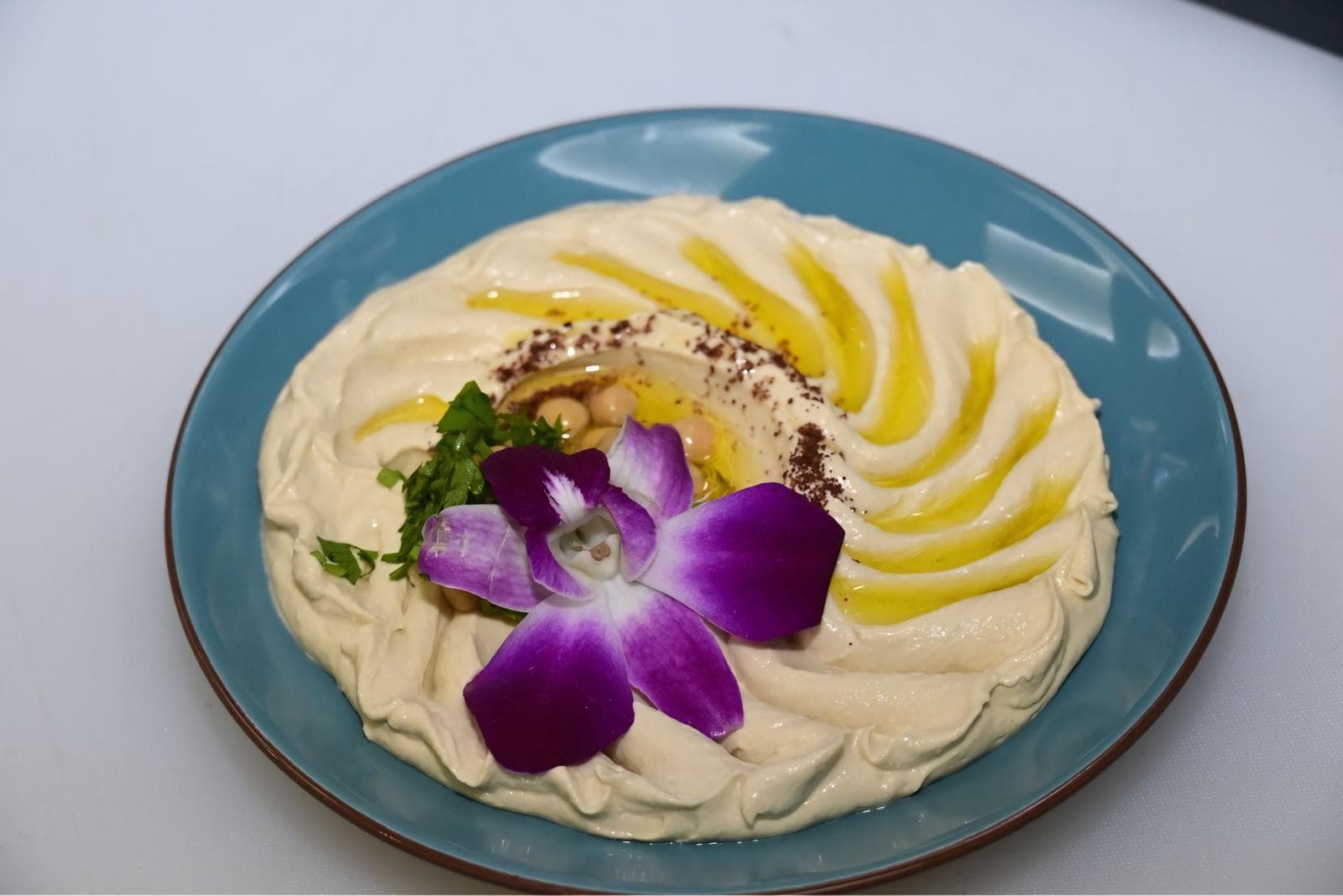 Hummus with olive oil, chickpeas, and herbs at Mediterra Houston