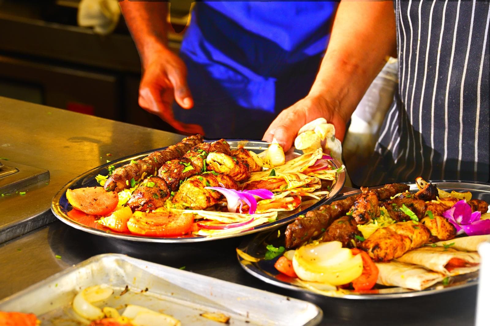 Koobideh Kebab with saffron rice, grilled tomato, and onion at Mediterra Houston