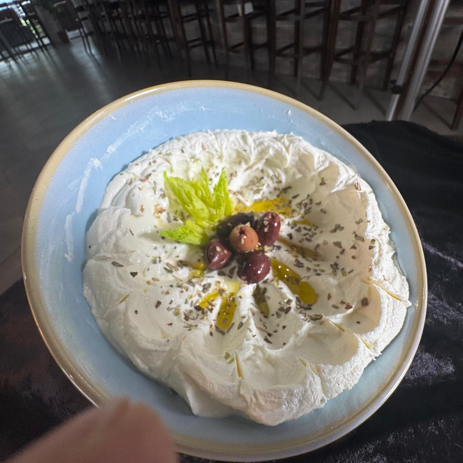 Labneh with olive oil, olives, and herbs at Mediterra Houston
